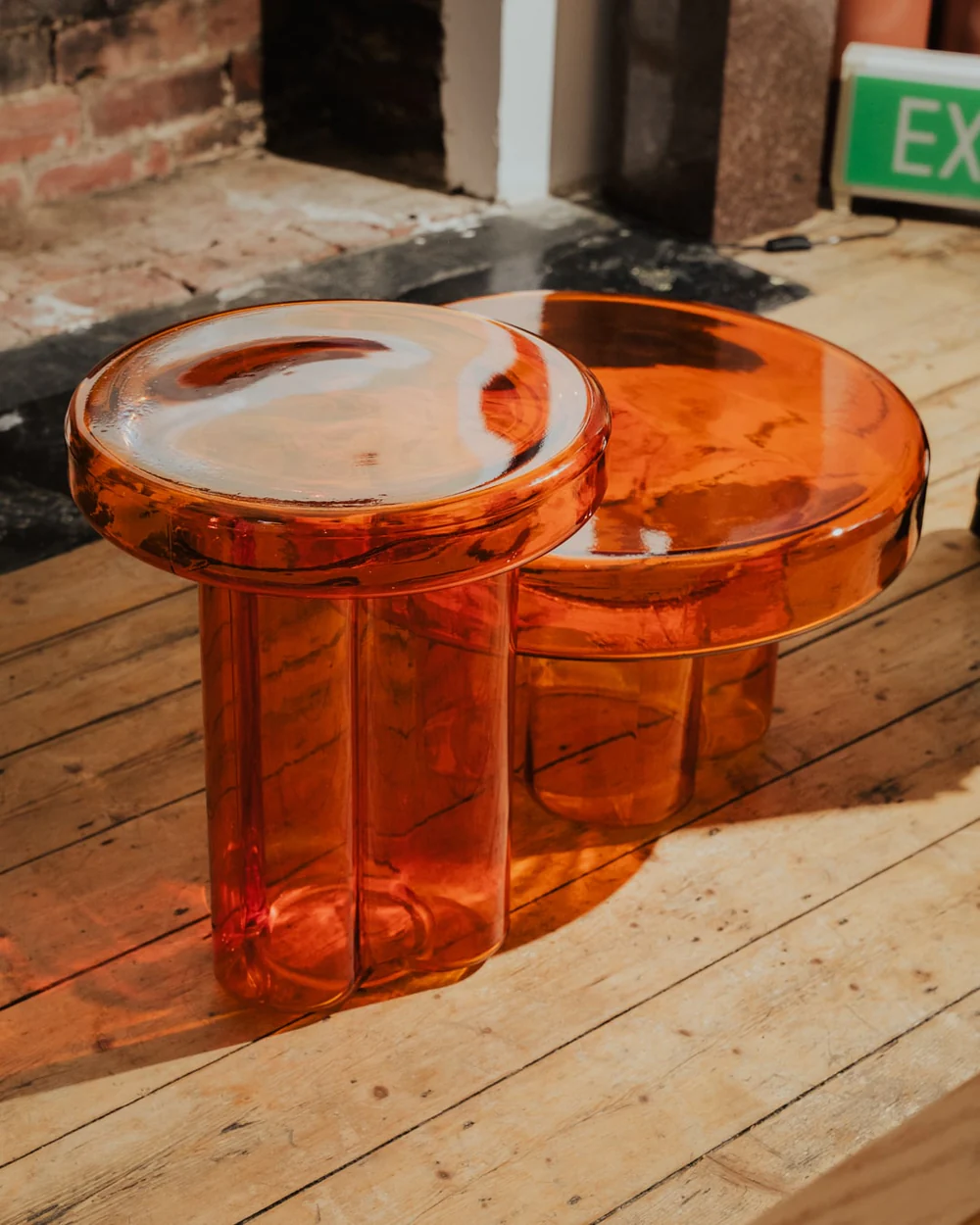 Petal-shaped amber glass table with a rippled, handblown design—perfect as a living room accent or small coffee table - vibehaus