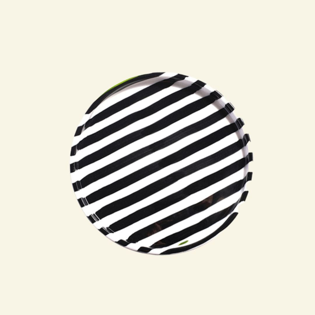 Black-White striped artisan handmade ceramic dinner plate on a beige background