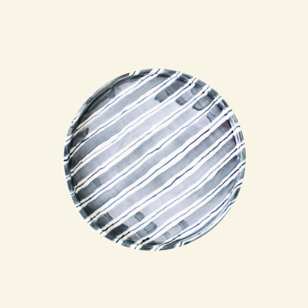 Blue-White striped artisan handmade ceramic dinner plate on a beige background