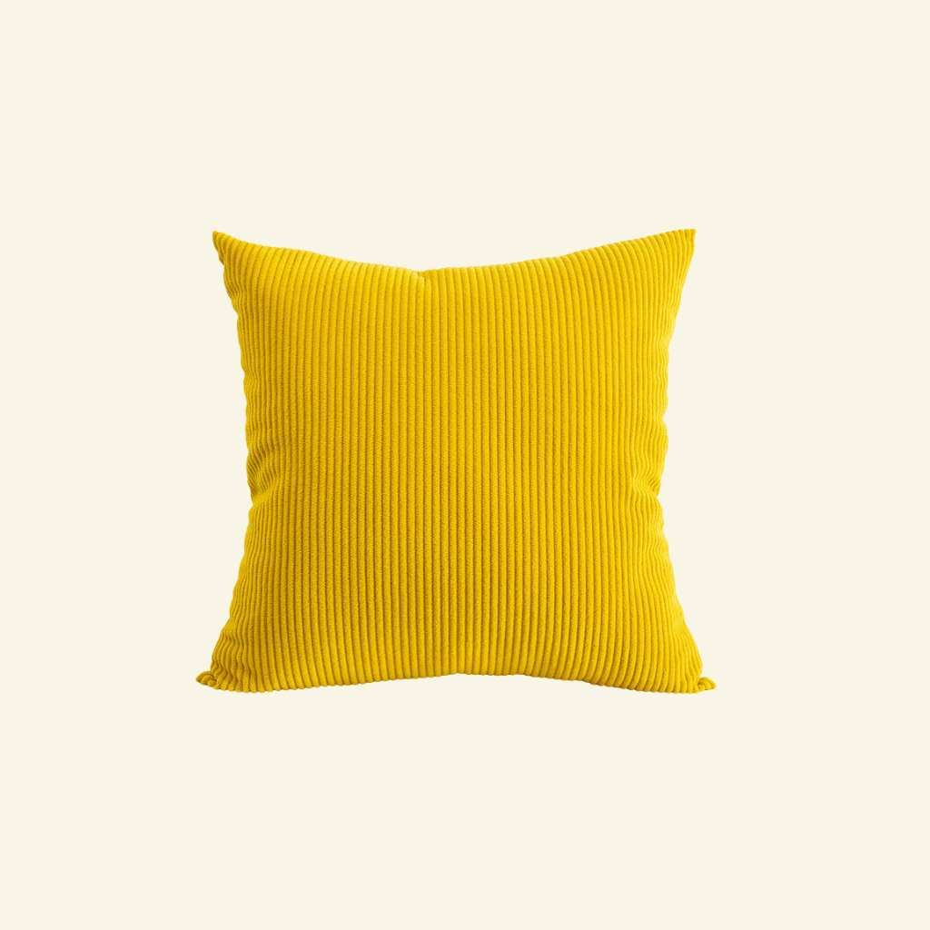 Yellow corduroy pillow on a light beige background