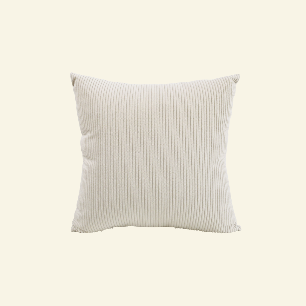 Textured corduroy pillow on a light beige background