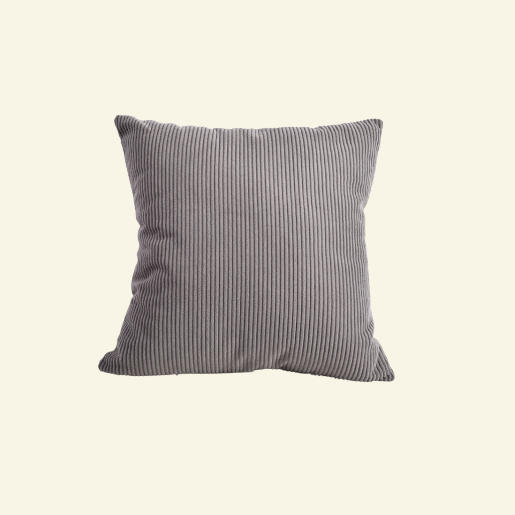 Striped corduroy pillow on a beige background