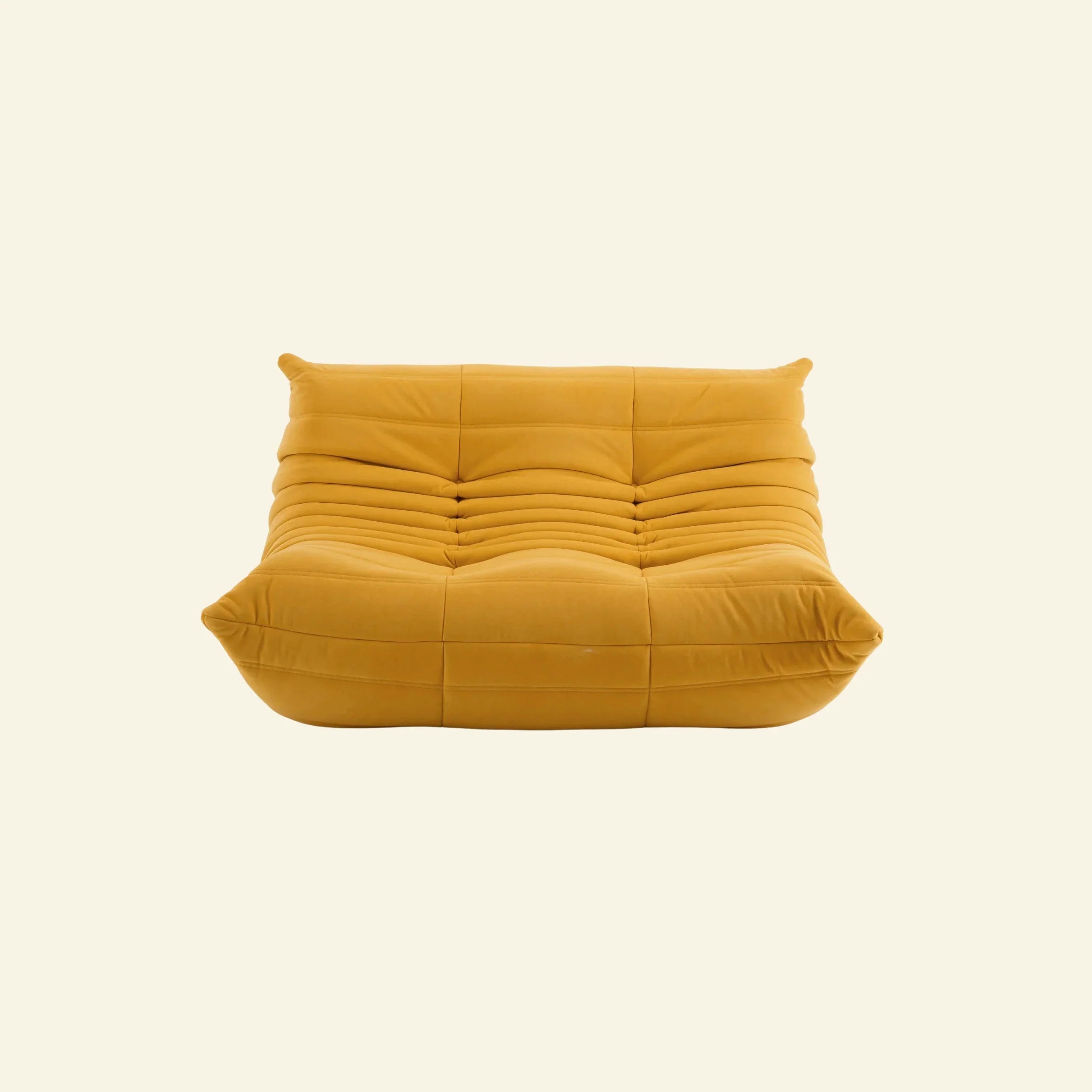 togo sofa dupe in yellow velvet on a warm neutral studio background by vibehaus