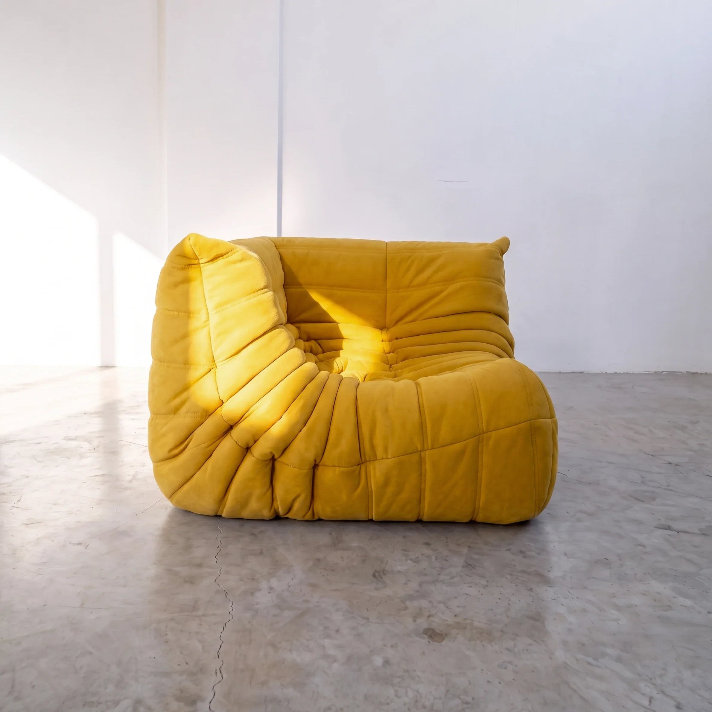 togo sofa dupe corner module in yellow velvet shown from an angled side view by vibehaus