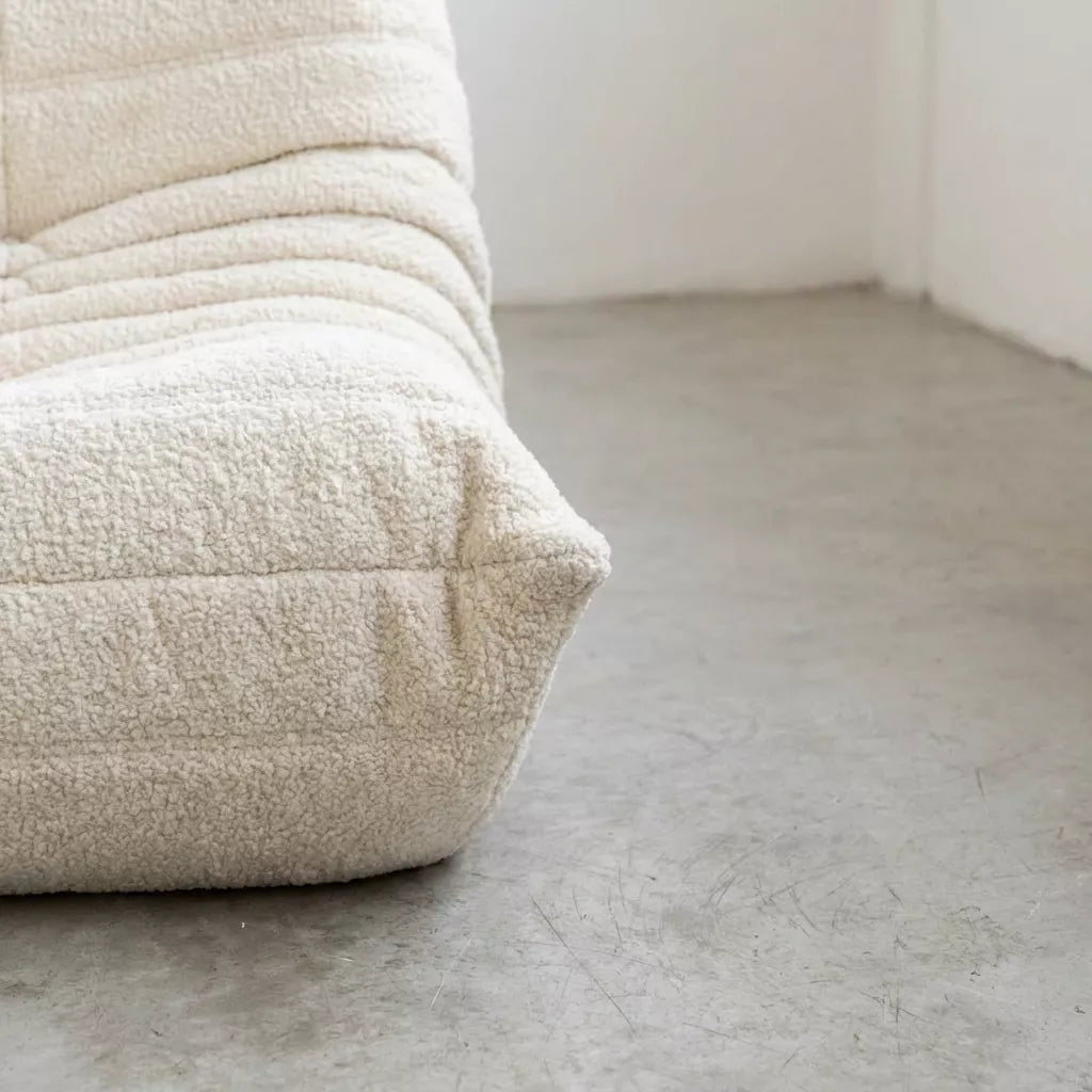 Close up of the bottom part of the Togo 2-seater Sofa dupe in white bouclé with Togo silhouette designed by michael ducaroy for ligne roset – custom-made by vibehaus