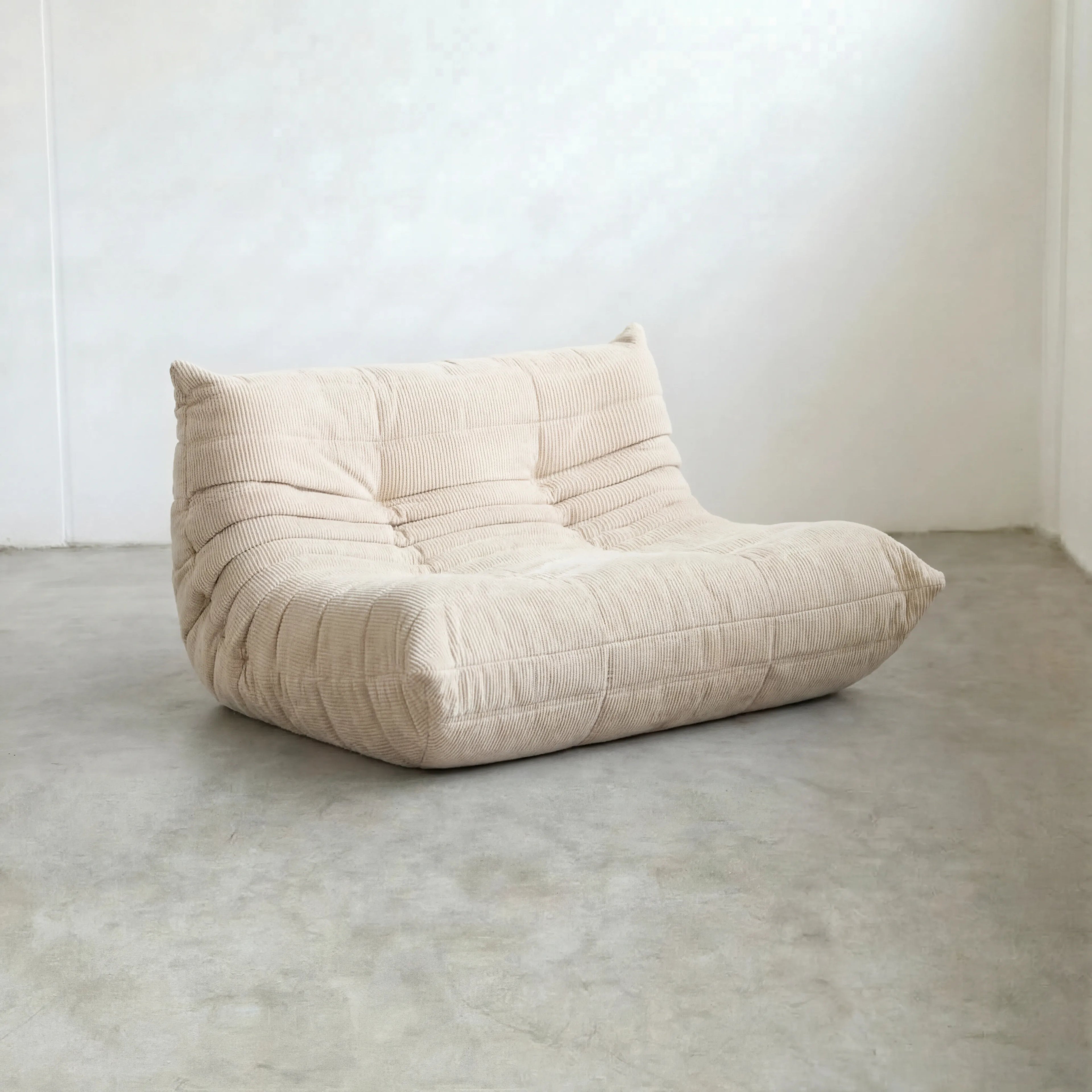 Togo 2-seater Sofa dupe in cream corduroy with Togo silhouette designed by michael ducaroy for ligne roset – custom-made by vibehaus