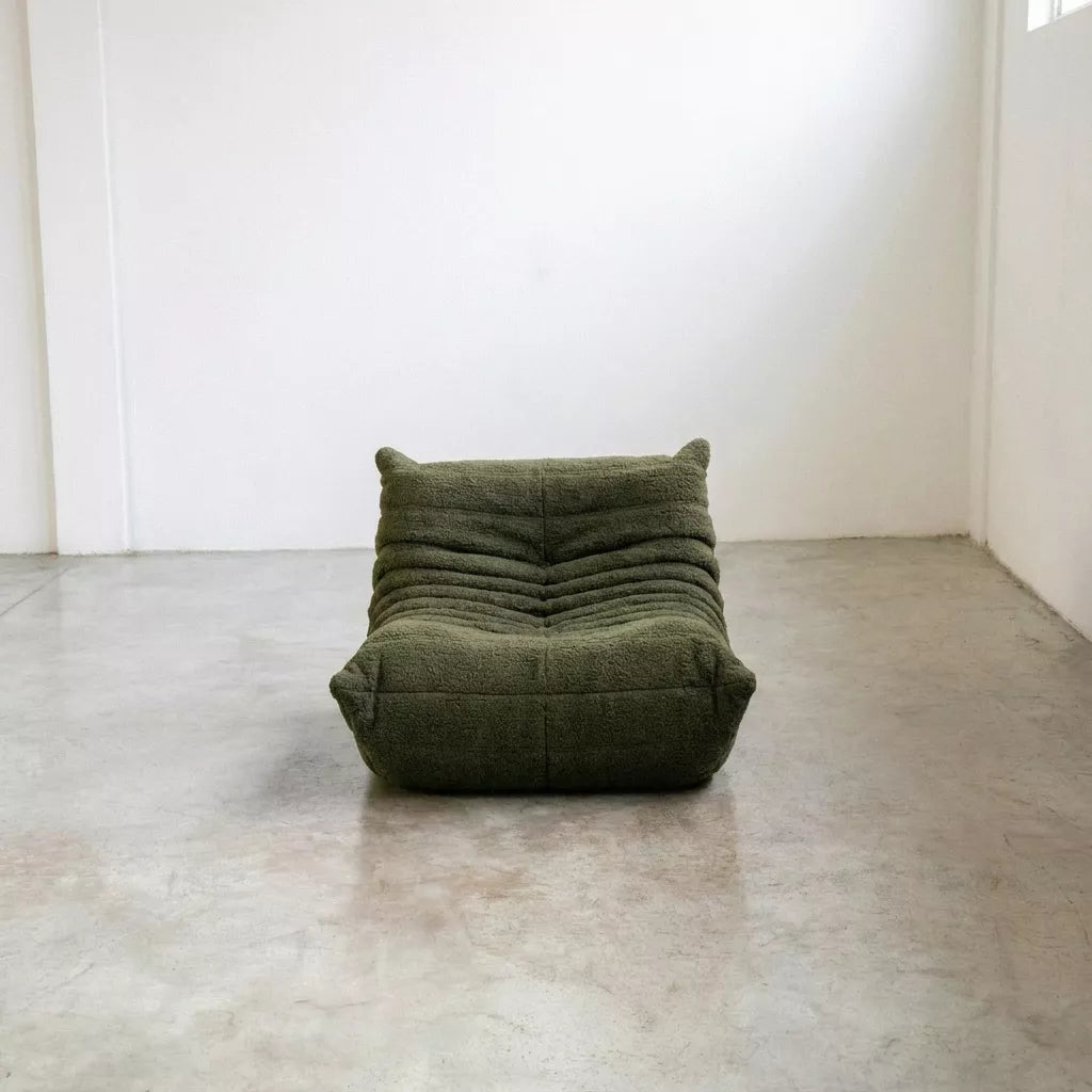 Replica of the green boucle Togo-chair by michael ducaroy– low, frameless design with plush channel tufting