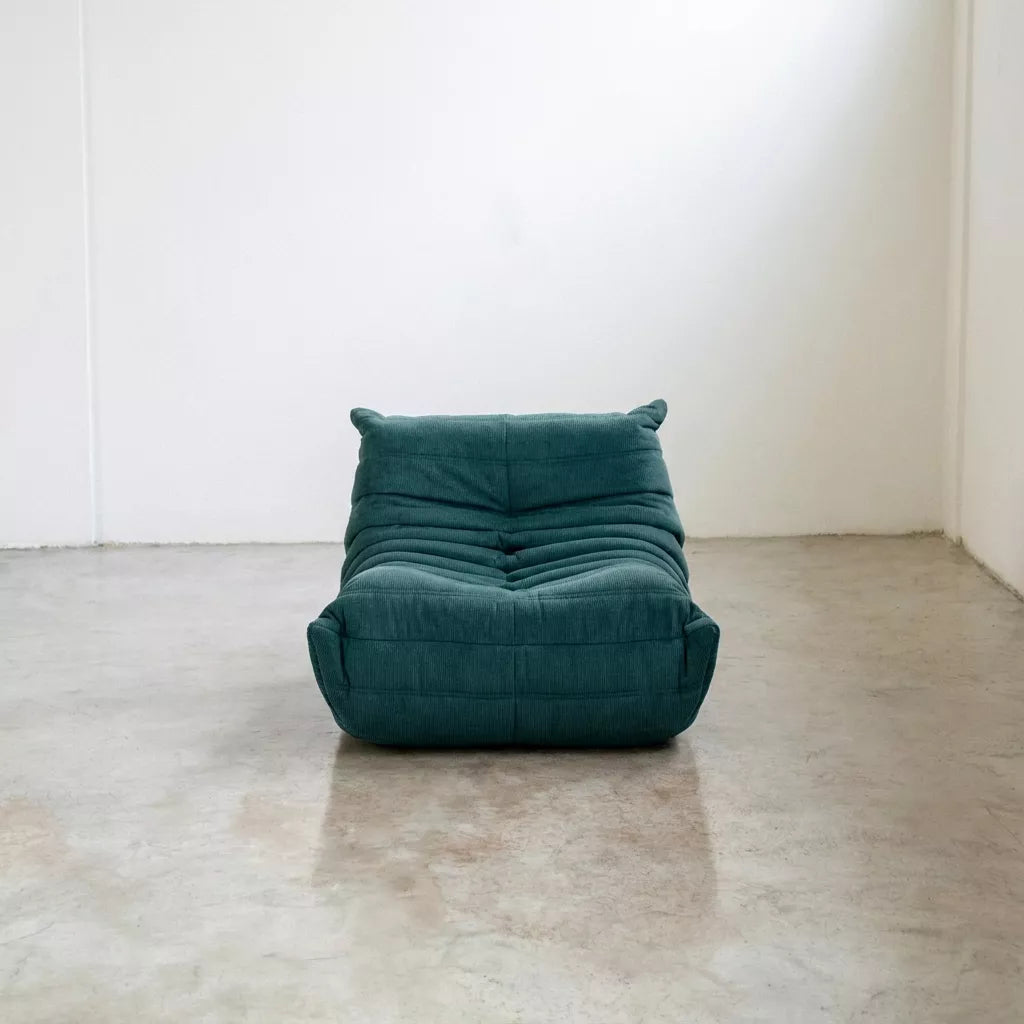 Replica of the turquoise corduroy Togo-chair by michael ducaroy– low, frameless design with plush channel tufting