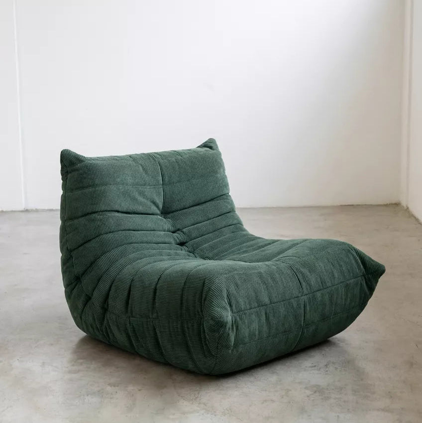 Replica of the green corduroy Togo-chair by michael ducaroy– low, frameless design with plush channel tufting