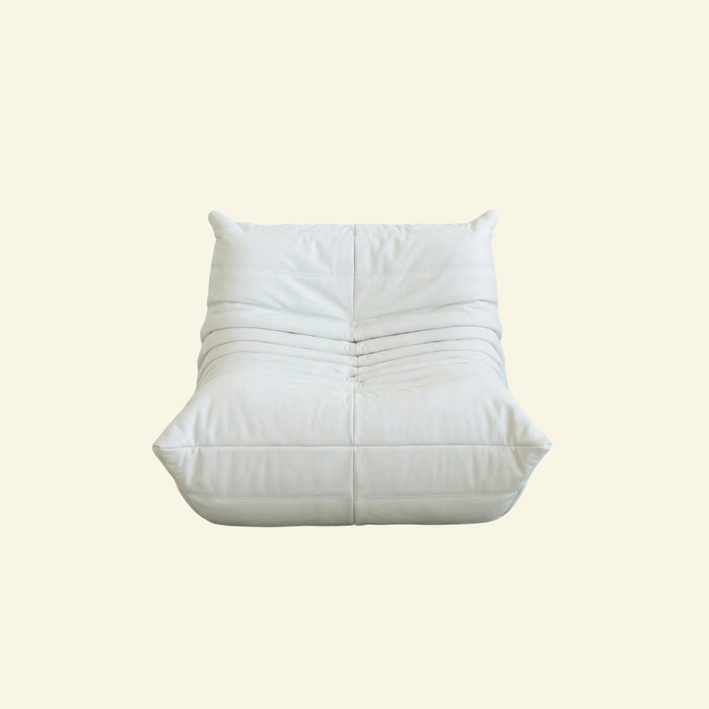 Togo Chair Dupe in white faux leather on a beige background by vibehaus