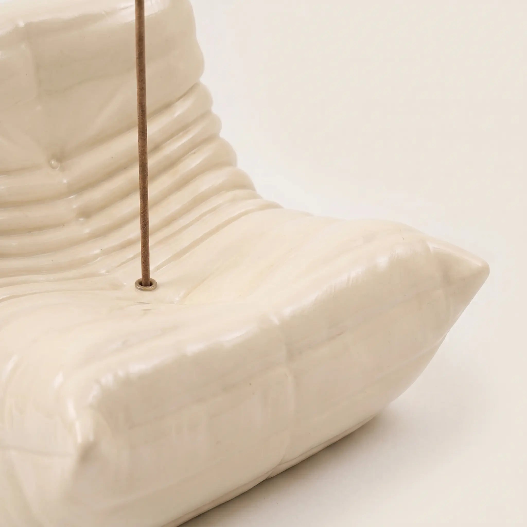 Close up of the togo incense holder in cream beige resin