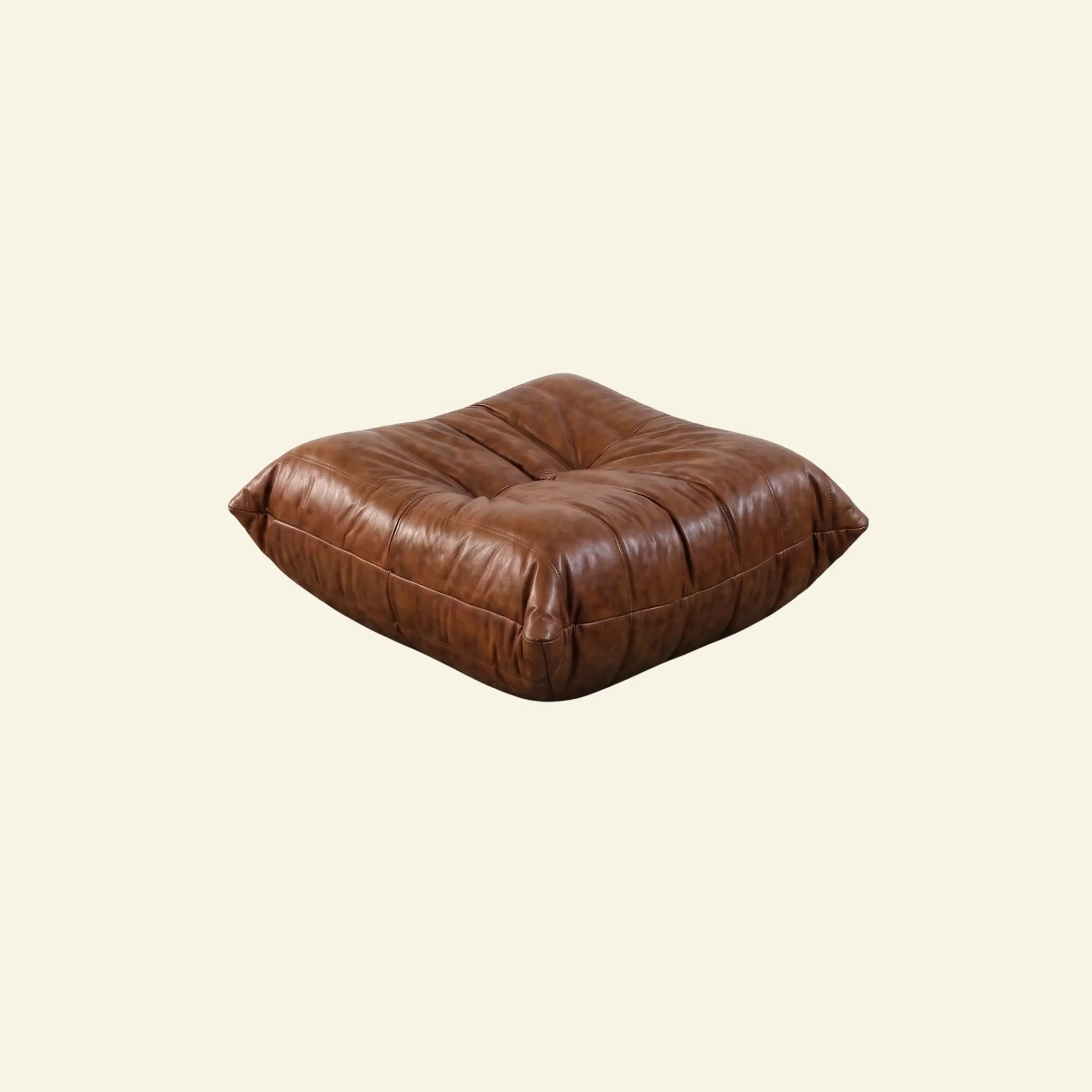 Brown togo leather ottoman dupe on a beige background