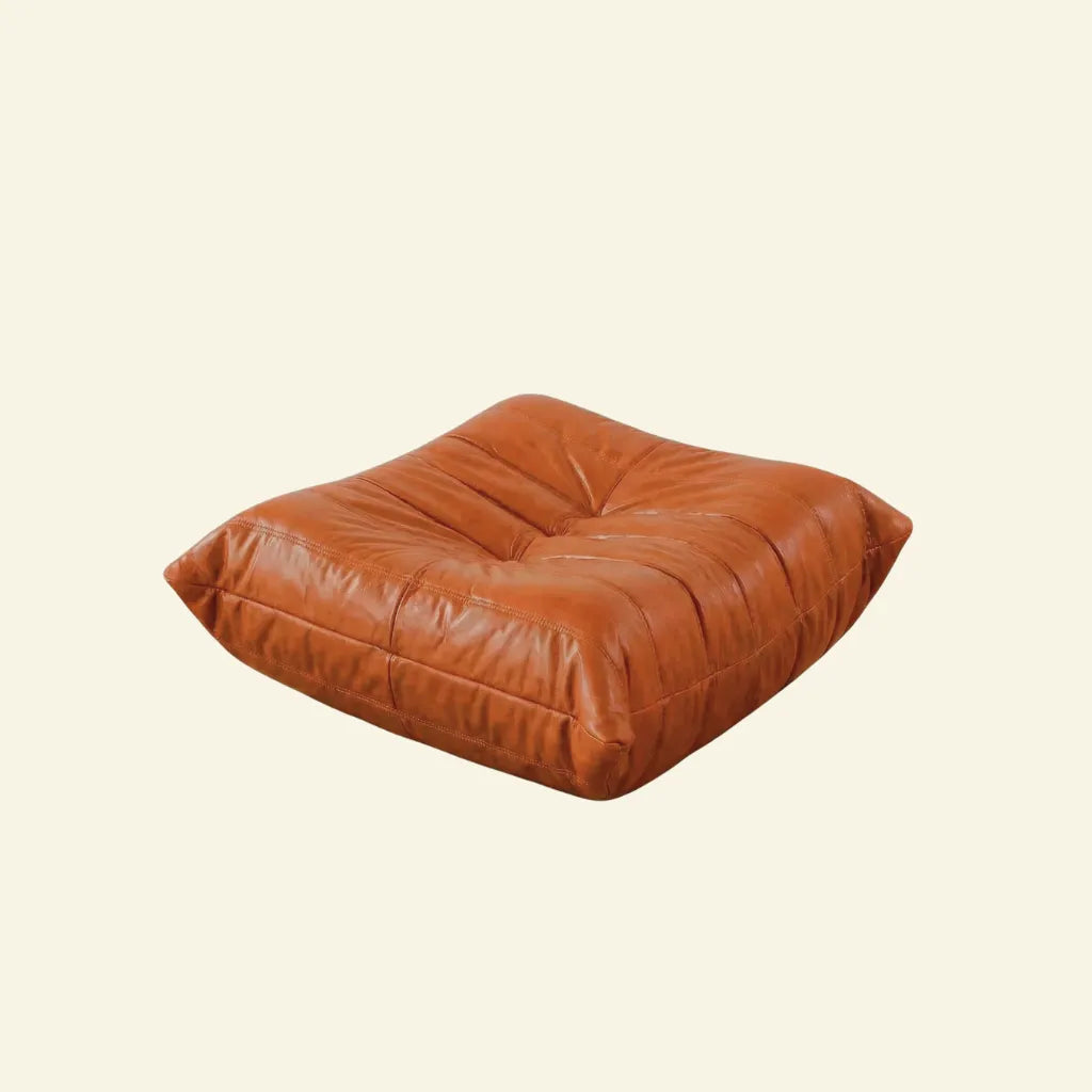 Cognac real leather togo ottoman dupe on a beige background