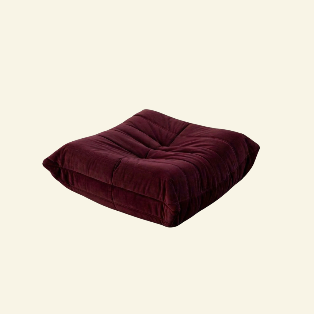 Togo Ottoman Dupe in burgundy velvet on beige background