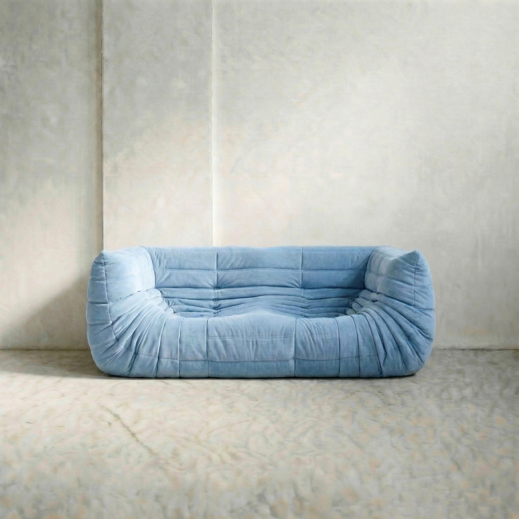 Togo Sofa Dupe in blue with armrests on a neutral background