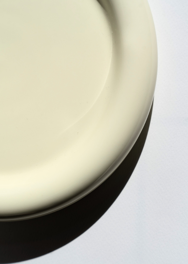 Chunky ceramic plate inspired by Gustaf Westman on a minimalist white backdrop