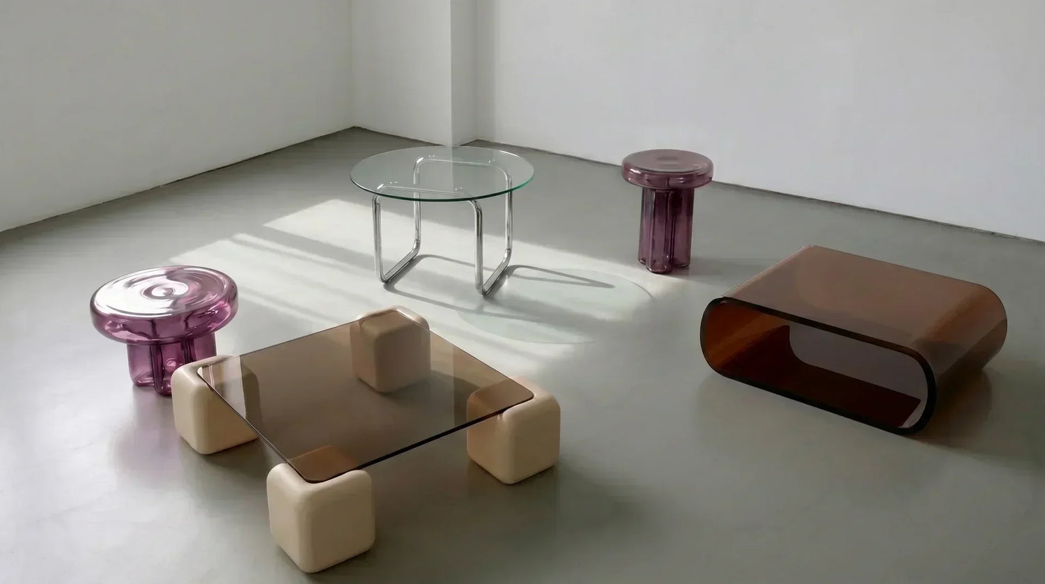 Three styled coffee table and sofa pairings: modular with travertine, mid-century with wood, modern minimal with glass