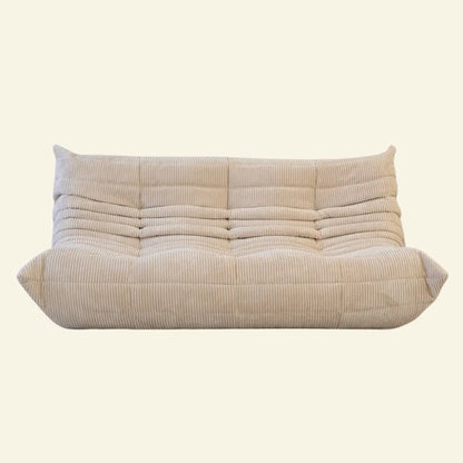 beige corduroy replica of the Togo-3-seater sofa by ligne roset – low, frameless design with plush channel tufting