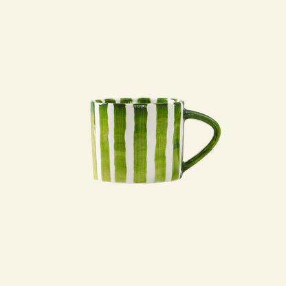 Green and white Artisan Ceramic Mug on a beige background