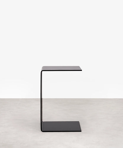 Modern grey c-shaped side table on a white background