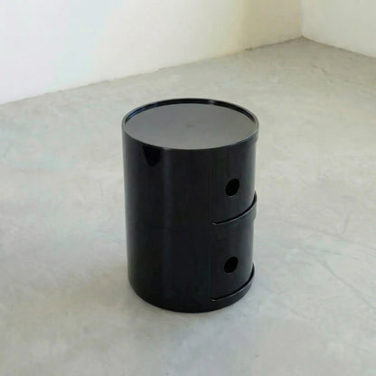 Black glossy round modular storage unit, Kartell Componibili dupe with two tiers in minimalist concrete studio