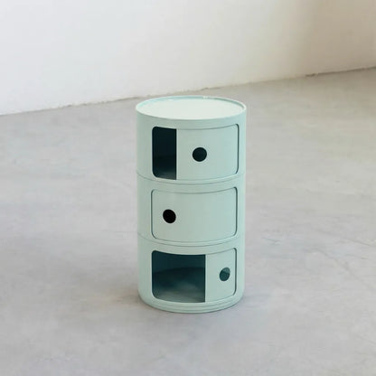 Kartell Componibili dupe round modular storage unit in light blue glossy plastic with three tiers on concrete floor in white studio
