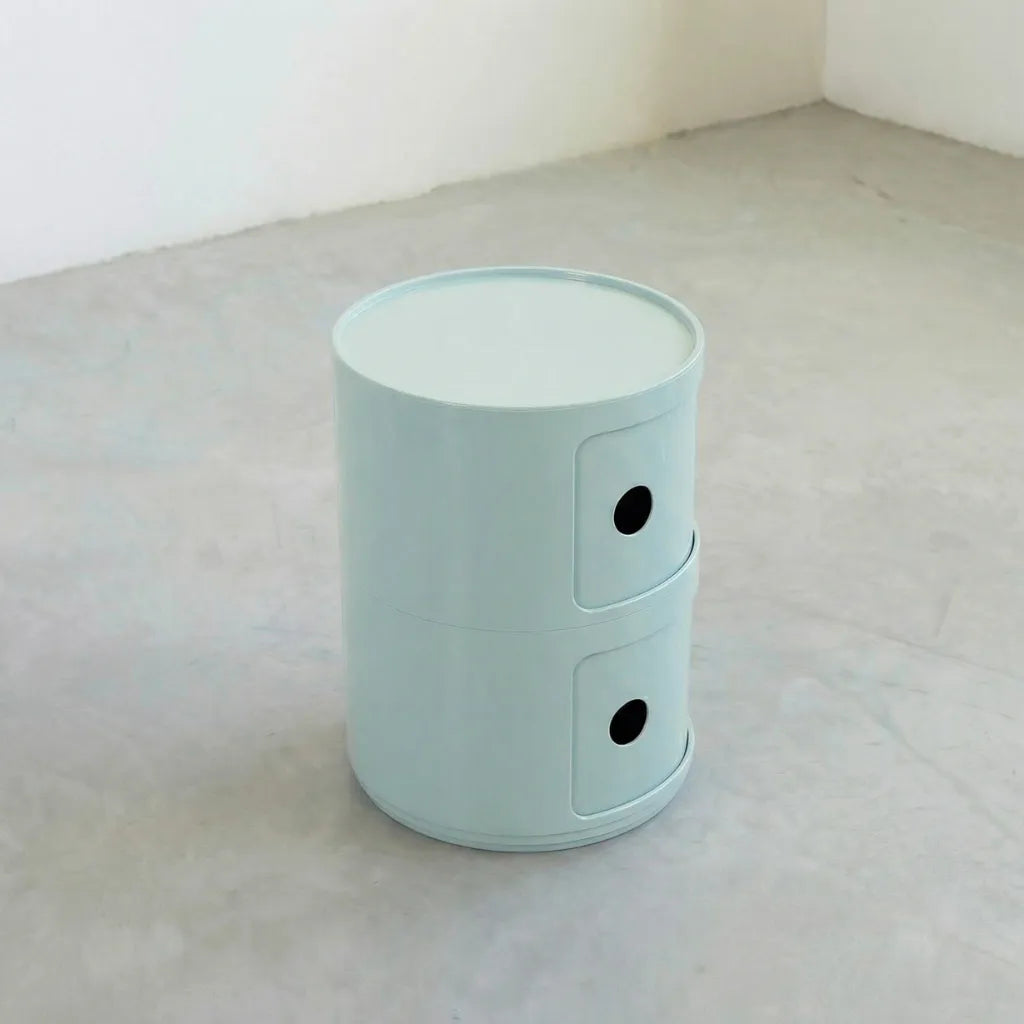 Kartell Componibili dupe round modular storage unit in light blue glossy plastic with two tiers on concrete floor in white studio