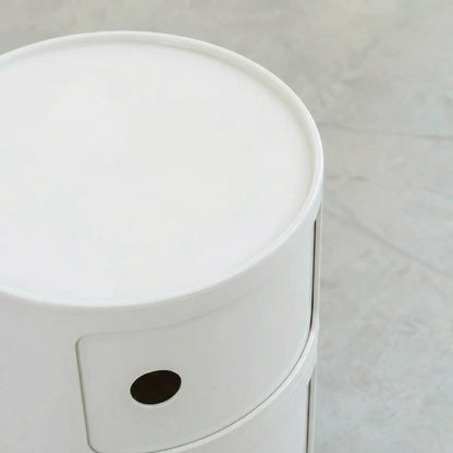 Close up of the Kartell Componibili dupe round modular storage unit in white glossy plastic with two tiers on concrete floor in white studio