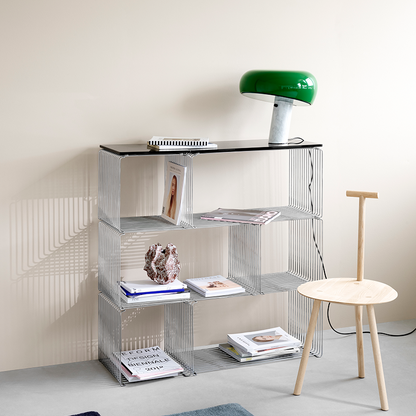 chrome wire cube modern metal shelving unit with books and decor items against a neutral wall.