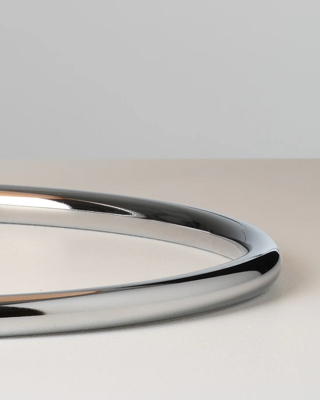 Close-up of a shiny metal ring on a light background