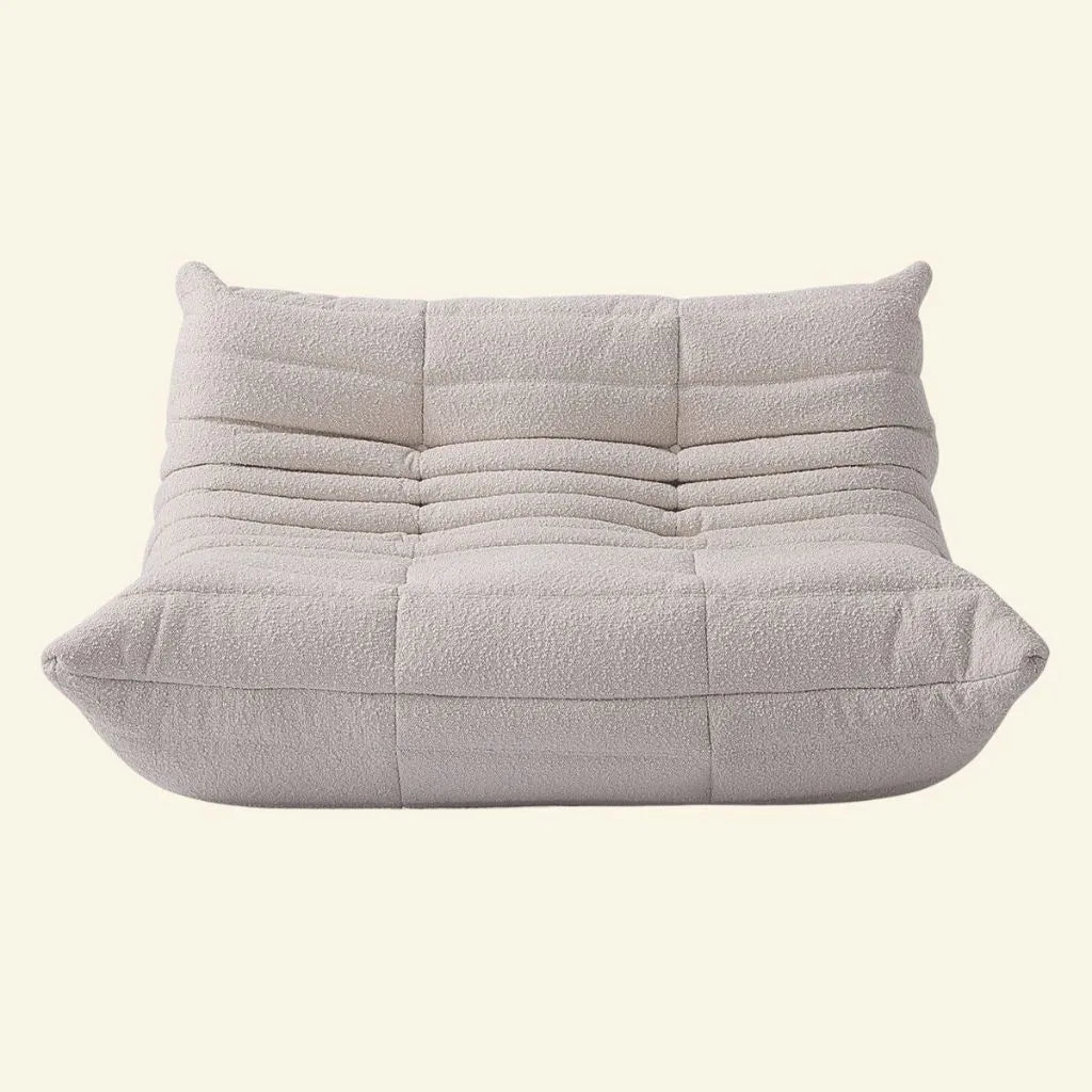 white boucle togo 2-seater replica on a beige background