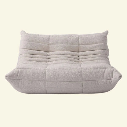 white boucle togo 2-seater replica on a beige background