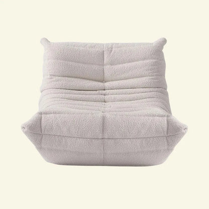 White Boucle togo chair replica on a light beige background