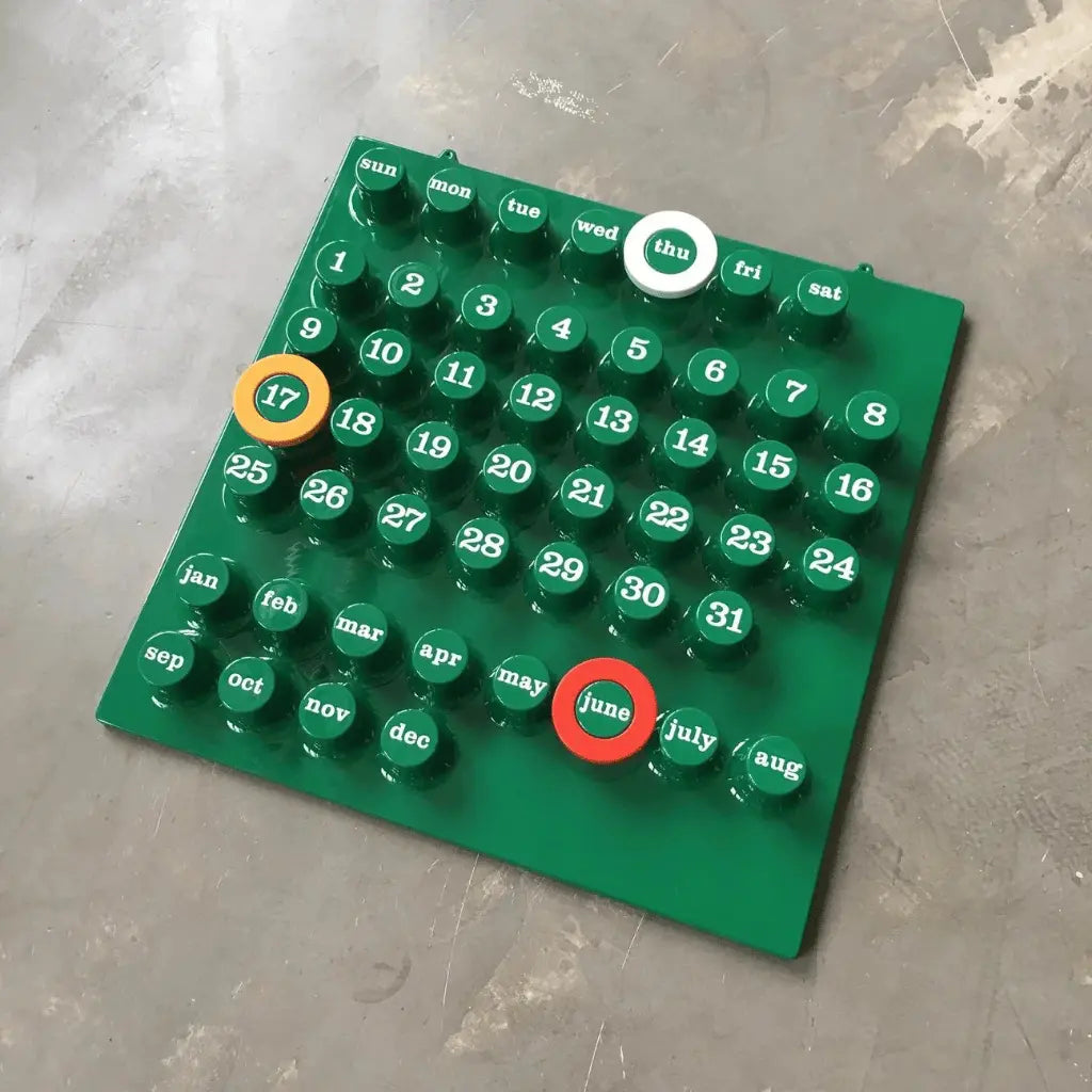 Green Ring-a-Date calendar dupe inspired by Giorgio Della Beffa design laid out on the floor.