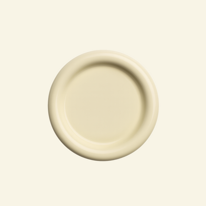 Round chunky thick ceramic plate on a beige background