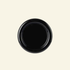 Round chunky thick ceramic plate in black  on a beige background