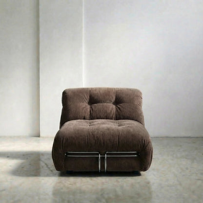 soriana chair dupe in chestnut corduroy angled view on gray floor with white wall background