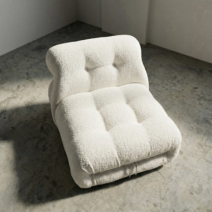 soriana chair dupe in white bouclé angled view on gray floor with white wall background