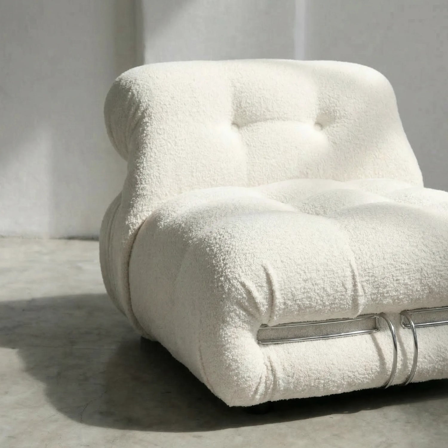 soriana chair dupe in white bouclé close-up with chrome clamp detail on light background