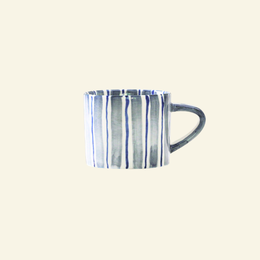Blue and white striped Artisan Ceramic Mug on a beige background