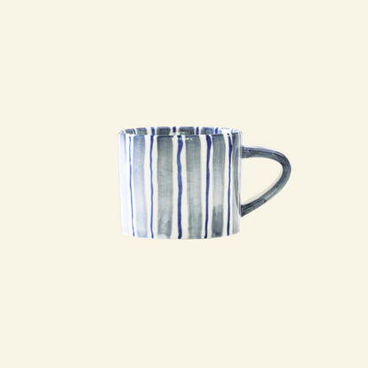 Blue and white striped Artisan Ceramic Mug on a beige background