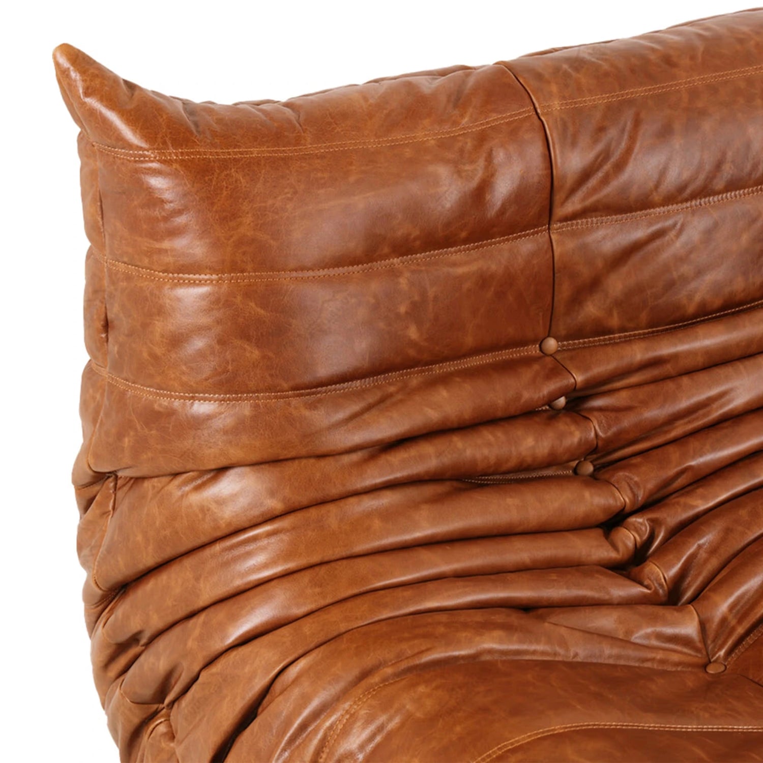 Close-up of a togo chair dupe brown waxy leather with visible stitching on a white background