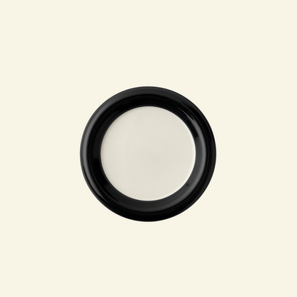 Two-Tone Chunky Ceramic Plate in black and white on a beige background on a beige background