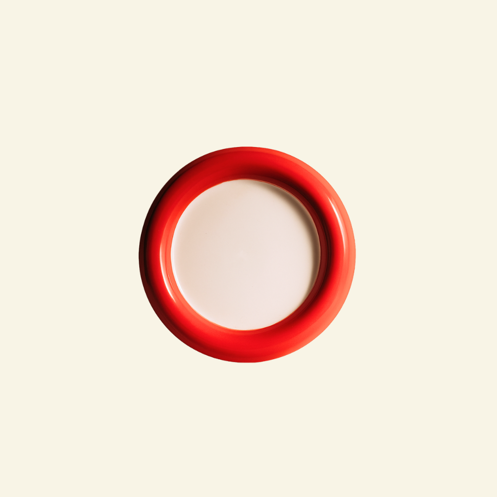 Two-Tone Chunky Ceramic Plate in red and white on a beige background