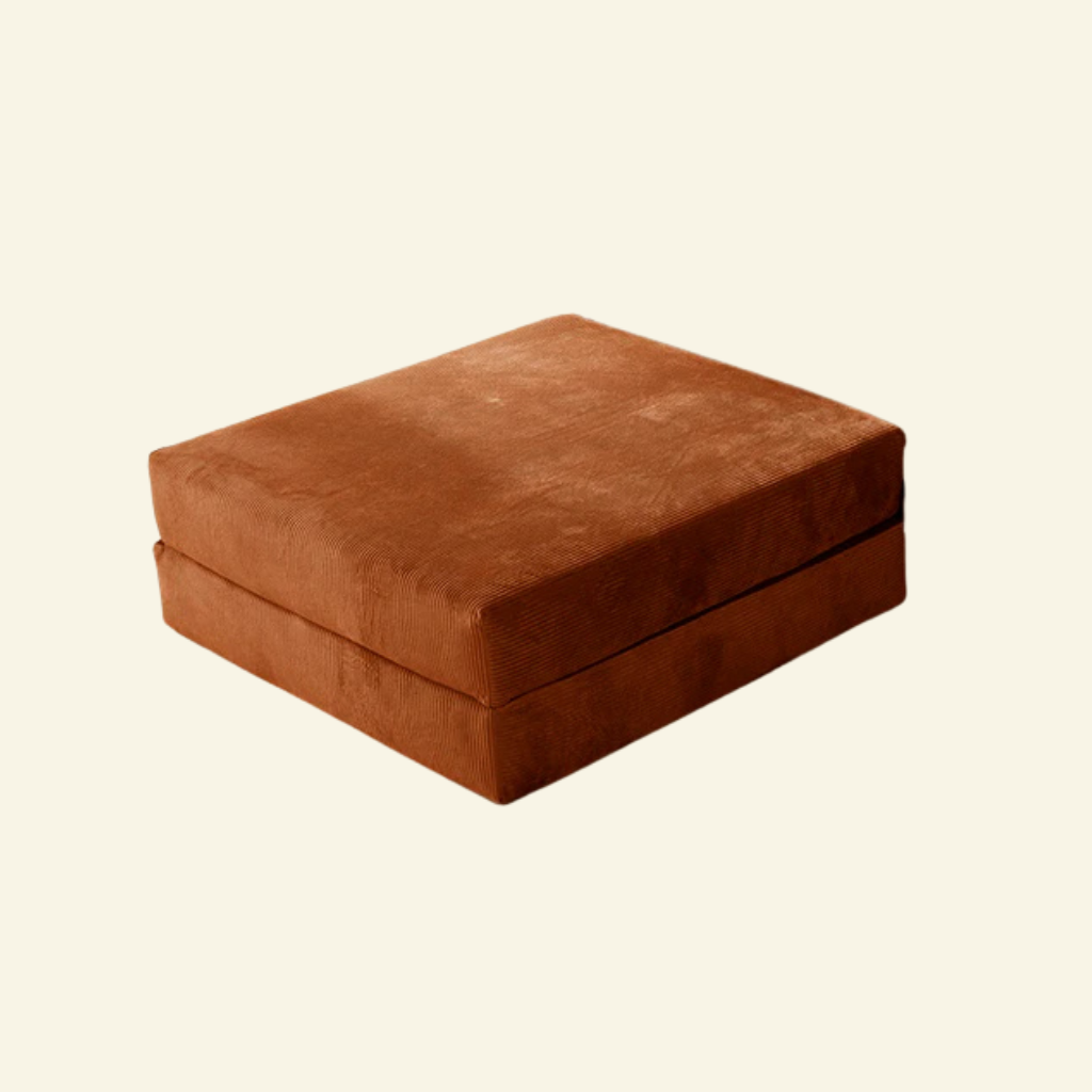 Orange Comfortform sofa ottoman on a beige background