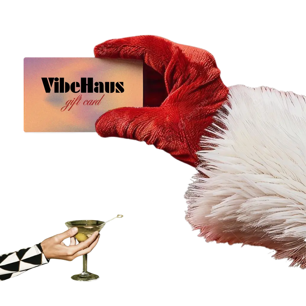 VibeHaus gift card held by a hand, next to a martini glass because they found the perfect gift for their designer friend.