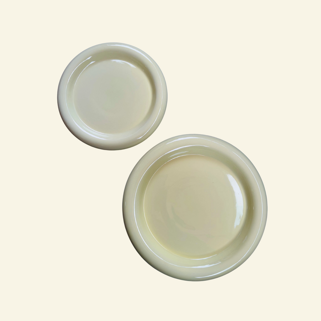 Thick round ceramic plate on beige background, by vibehaus