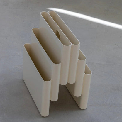 White Kartell magazine rack replica on a white surface