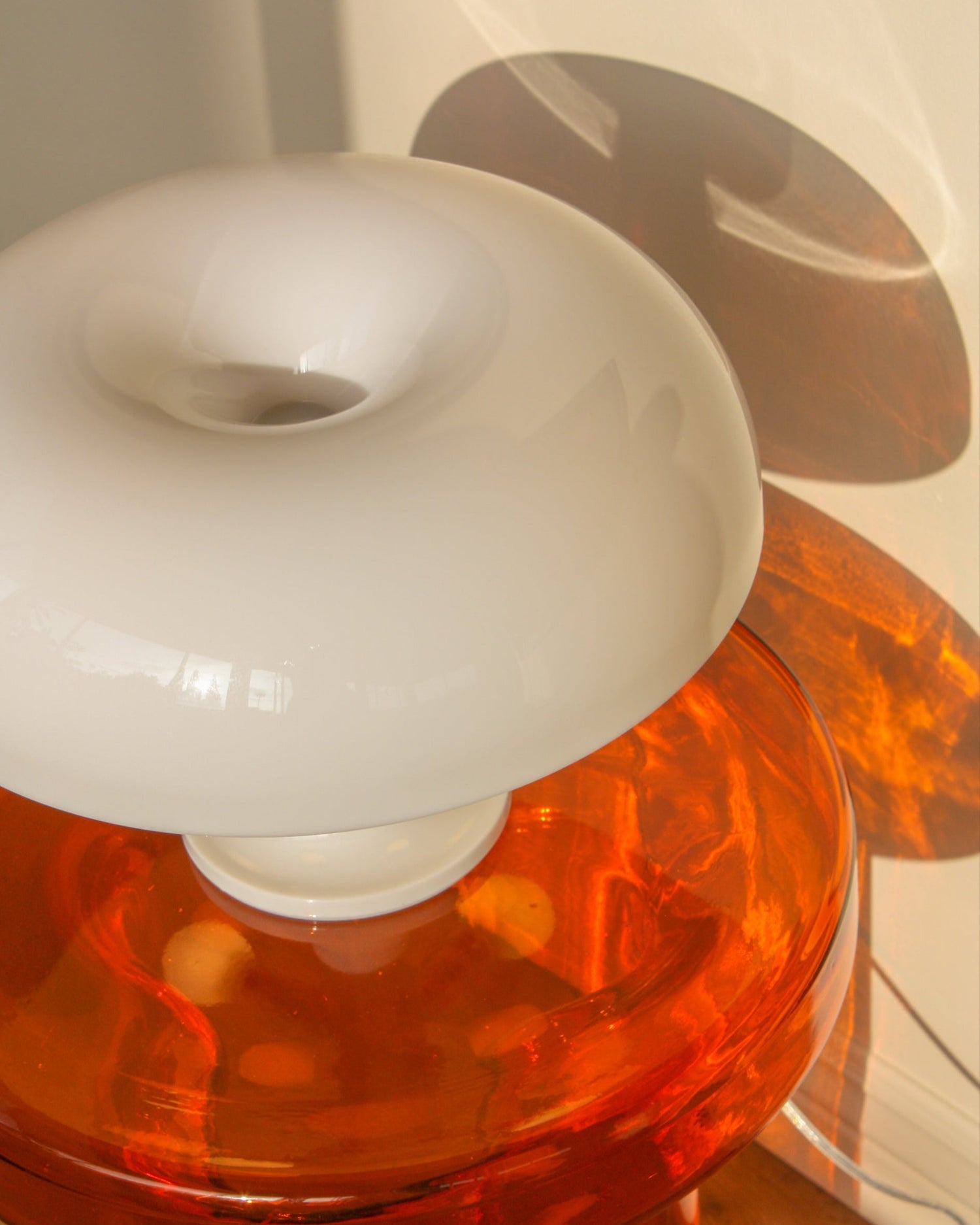 White Nesso Replica Table Lamp on an orange glass side table, furniture and lamp made by vibehaus