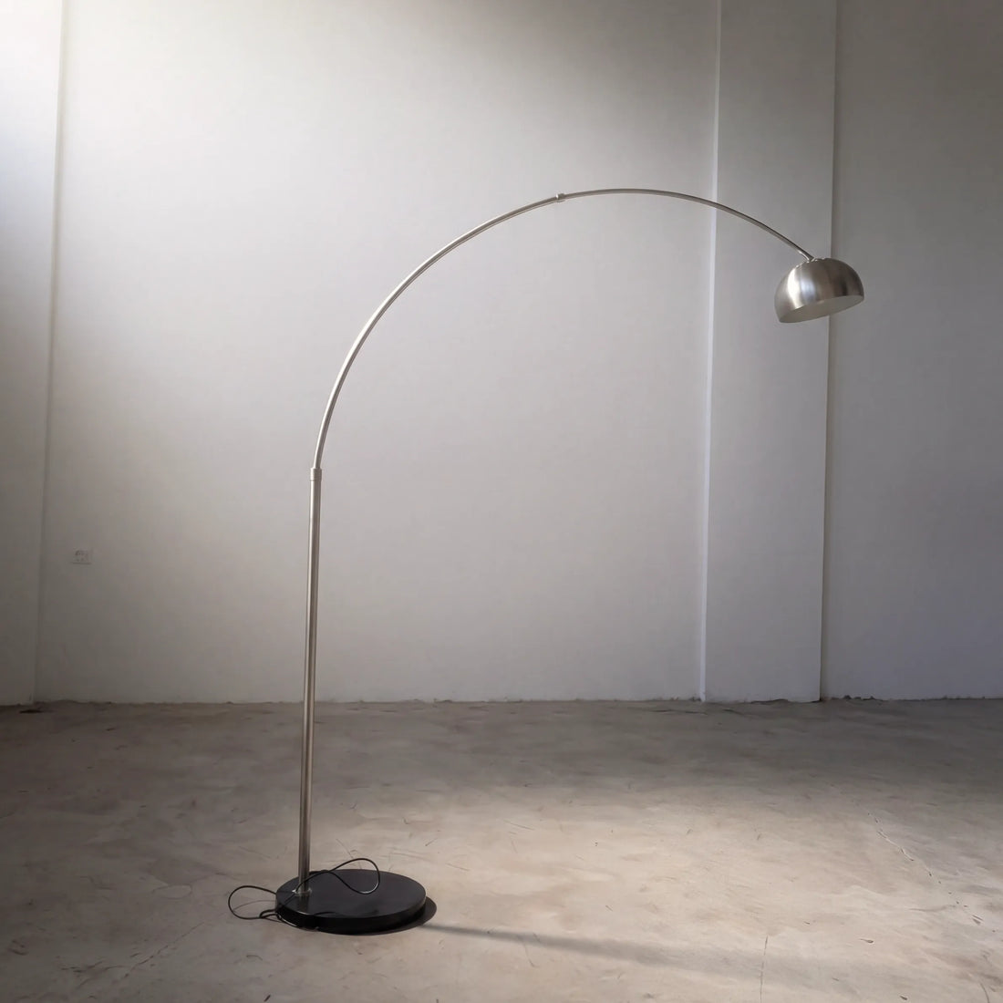 Aura Arc Floor Lamp, a modern arc floor lamp with a curved silhouette for living rooms, side view